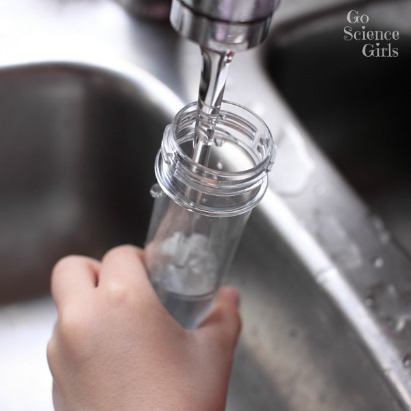 Little hands filling up test tubes - go science kids