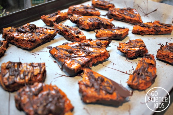 Drizzling chocolate over honeycomb to make violet crumble