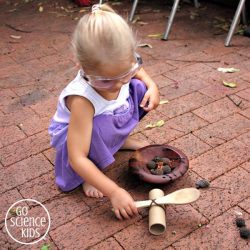 Toddler playing with a DIY catapult