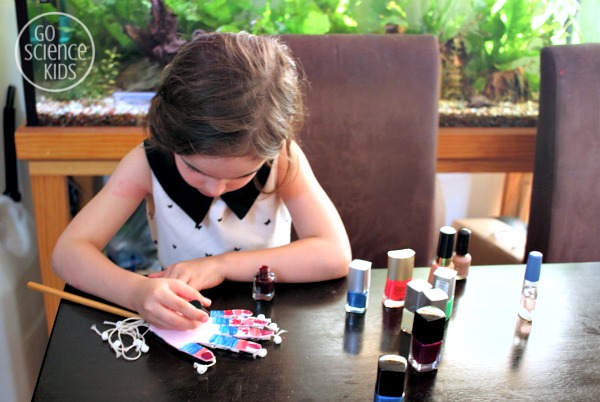 Jewel adding crazy nailpolish designs to her hand model