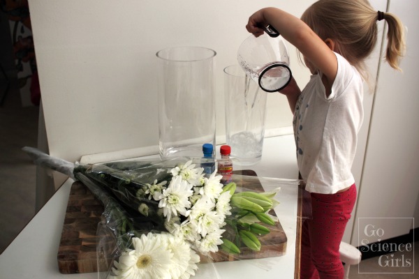 Pour water into the vases