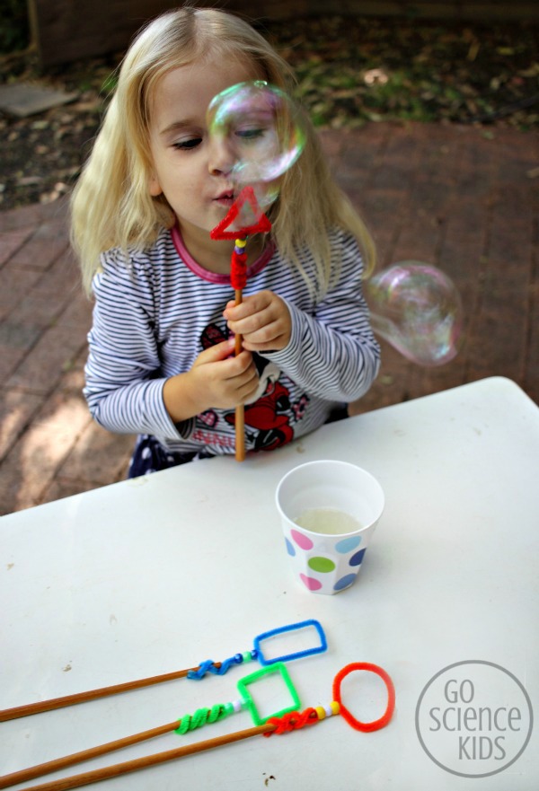 Blowing bubbles with the triangle shaped bubble wand