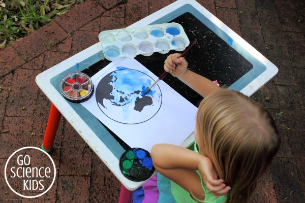 Painting the earth and the pacific ocean with blue watercolours