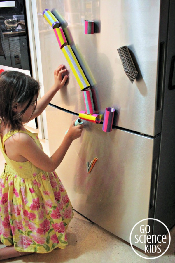 Make a DIY magnetic marble run for the fridge using toilet paper rolls and washi tape!